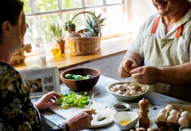 Close up of two people preparing fresh food as they apply nutrigenomics and functional medicine into practice