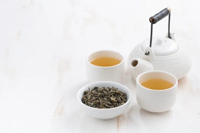 Tea and teacups in white background, many foods contain lead and can be a factor in disease.