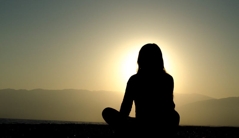 shadow_figure_woman_looking_out_at_sunset_view-1